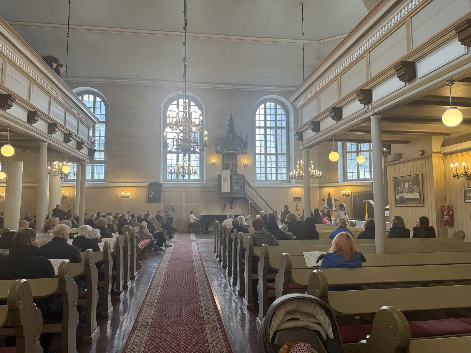 The congregation in the pews of St Elizabeth’s Church, viewed from the central aisle towards the pulpit.